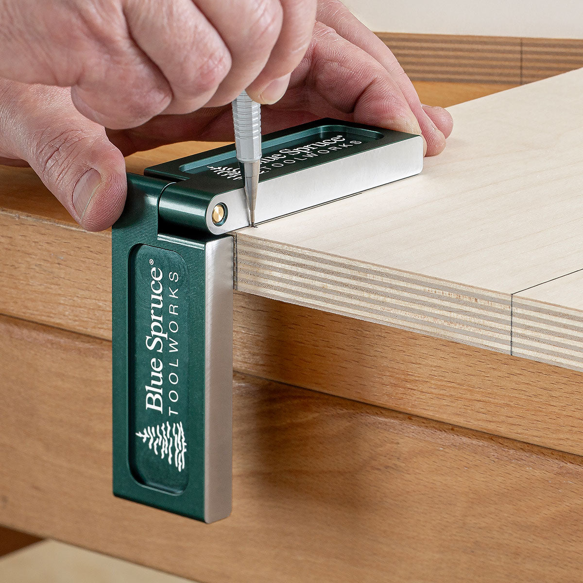 Drawing cross-dowel layout lines on Baltic Birch plywood using Folding Saddle Square.