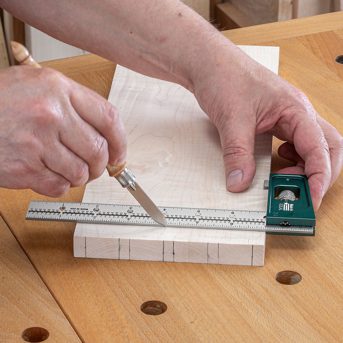 Using the 90-degree side of the head to scribe the base of the tails using a Blue Spruce Classic Marking Knife.