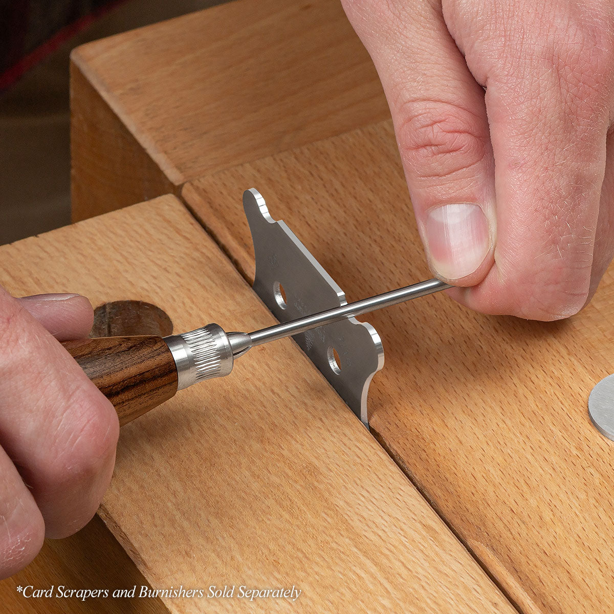 The Bolivian Rosewood .125 Solid Carbide Burnisher sharpening the Small Contoured Card Scraper.