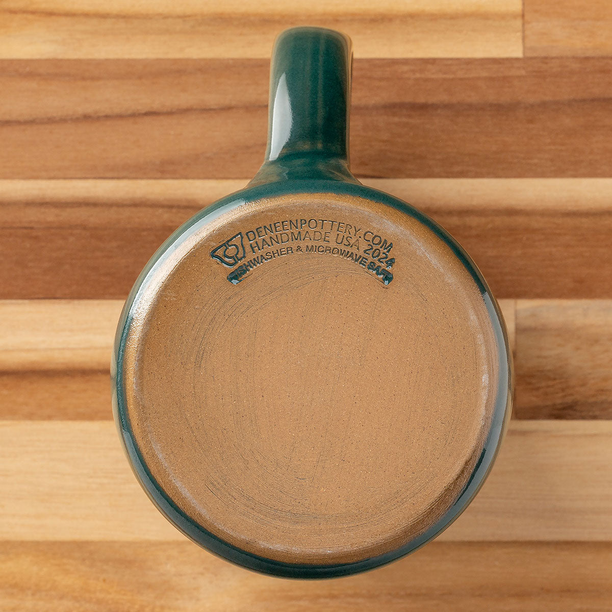 The Blue Spruce 2024 Signature Mug is handmade by Deneen Pottery.