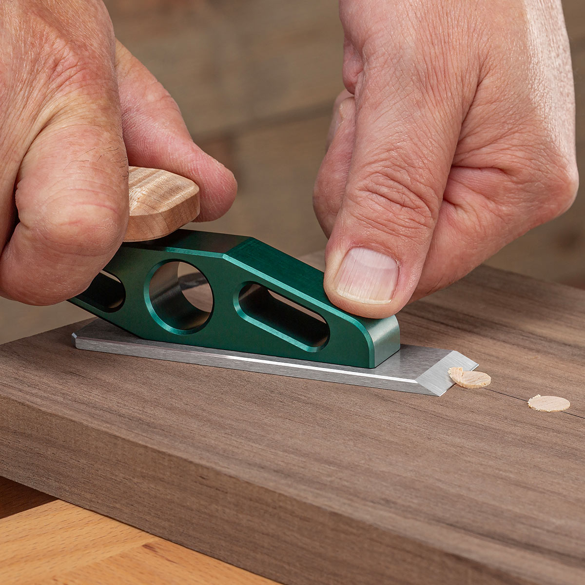 Chisel Plane with flat blade iron trimming plugs on a workpiece.