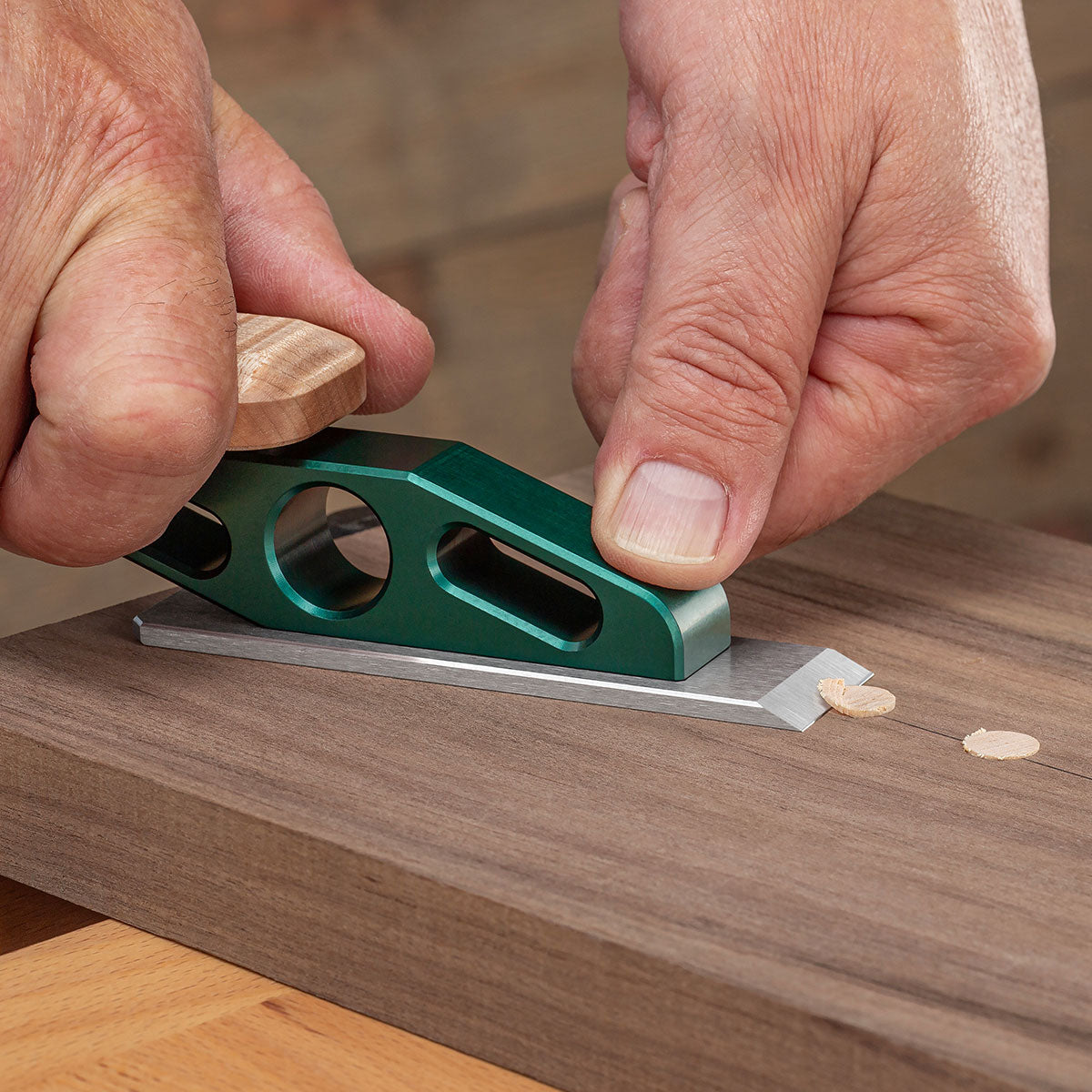 The Optima Chisel Plane with a flat blade iron effortlessly trimming plugs from a workpiece.