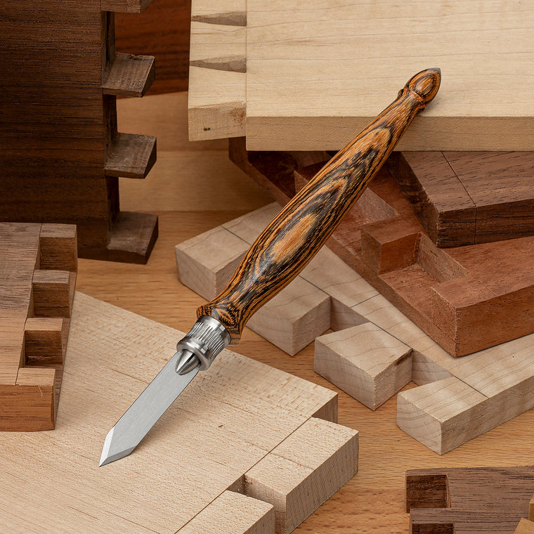The Blue Spruce Classic Marking Knife with Bocote handle. Bocote has a striking grain pattern with a yellowish-brown color mixed with dramatic brown to black striping.