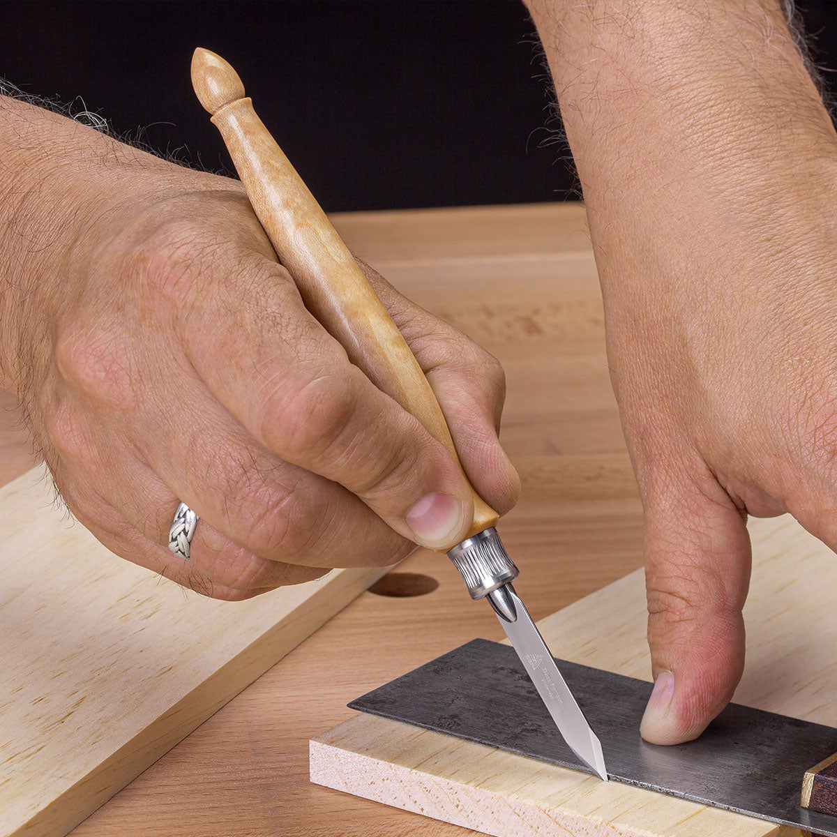 The spear-point blade design works equally well with the reference on the right or left…just flip the knife over to place the flat side against your square or straight-edge. 
