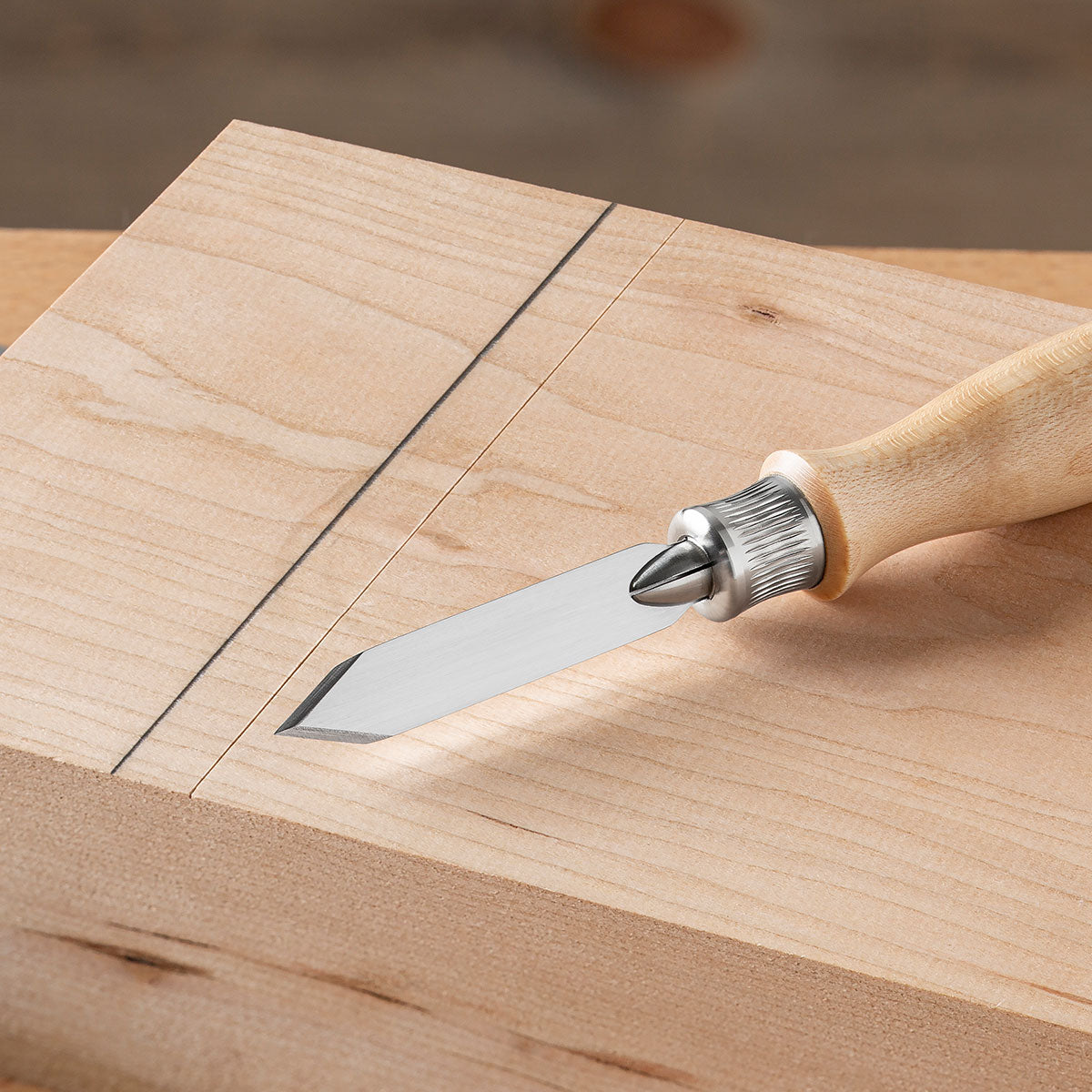 A pencil line gives you nothing but a target. A marking knife gives you a physical impression in the wood which guides your saw or chisel.
