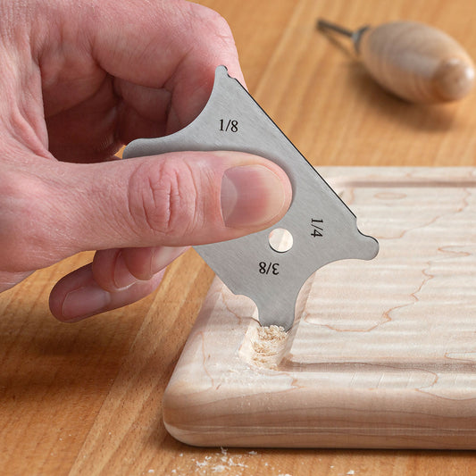 The Small Contoured Card Scraper cleaning out a juice groove.