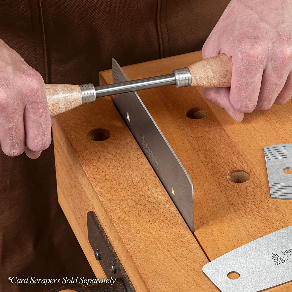 Curly Maple Dual-Handle Burnisher being pulled across the bottom cutting edge of a Blue Spruce Card Scraper.