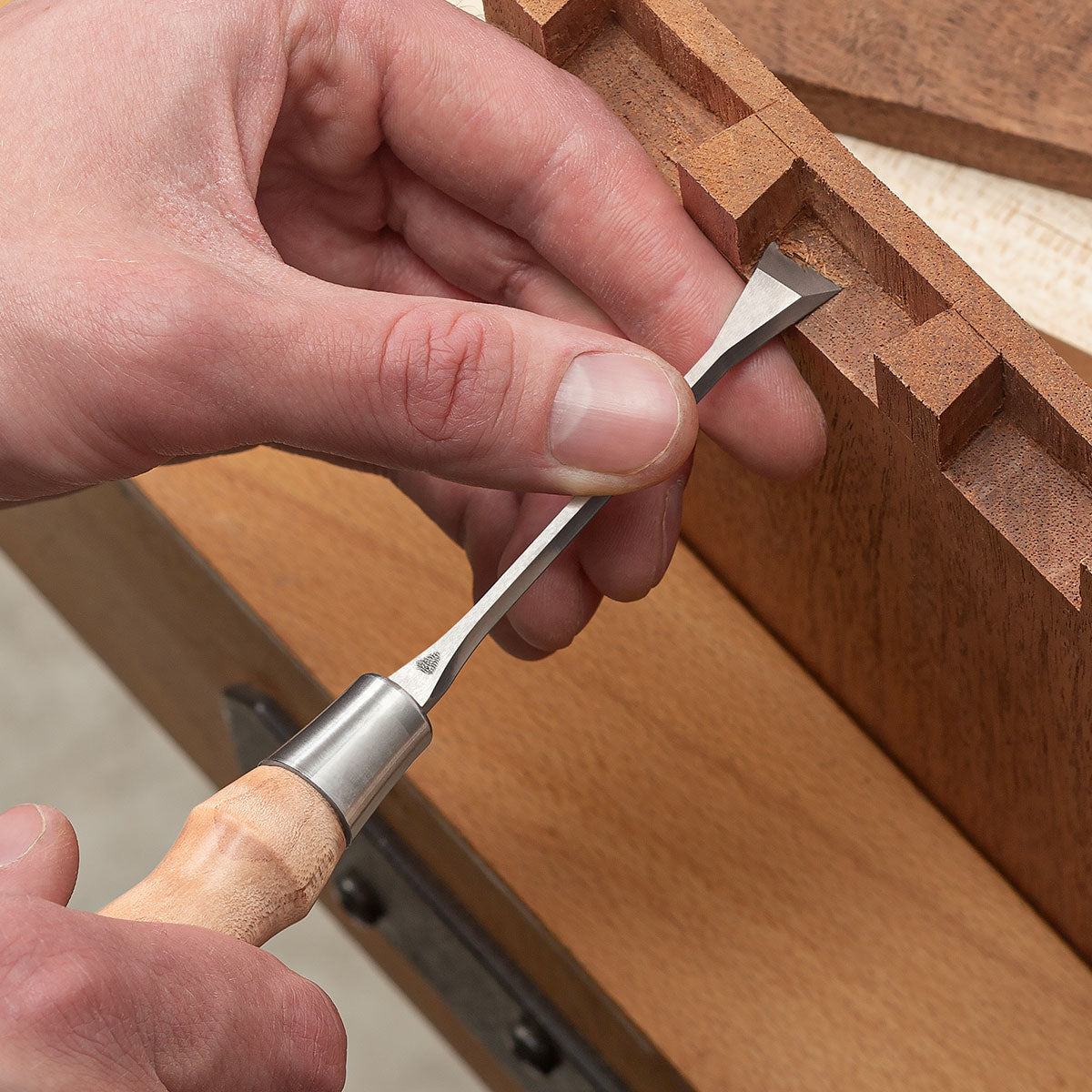 Fishtail Chisel cleaning an inside edge of a cut dovetail.