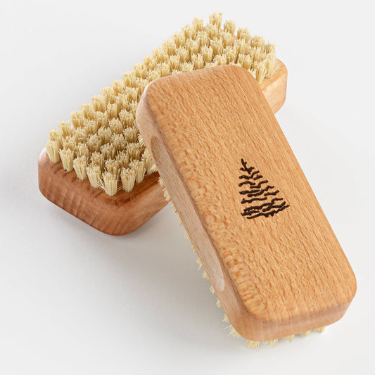 Two wooden brushes with bristle heads on a light gray background