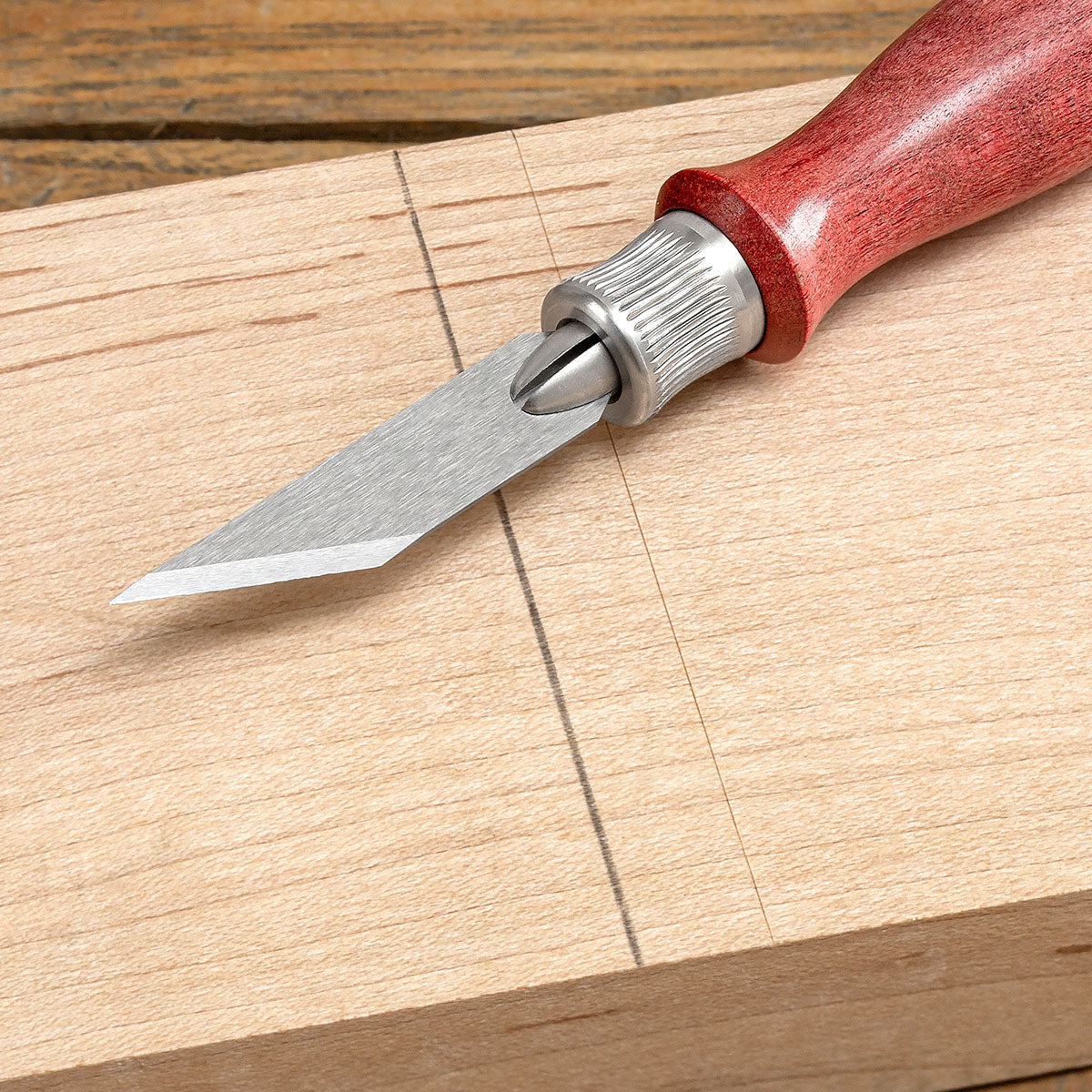 Closeup of the comparison between a thick mark by a pencil and a fine mark by a knife.
