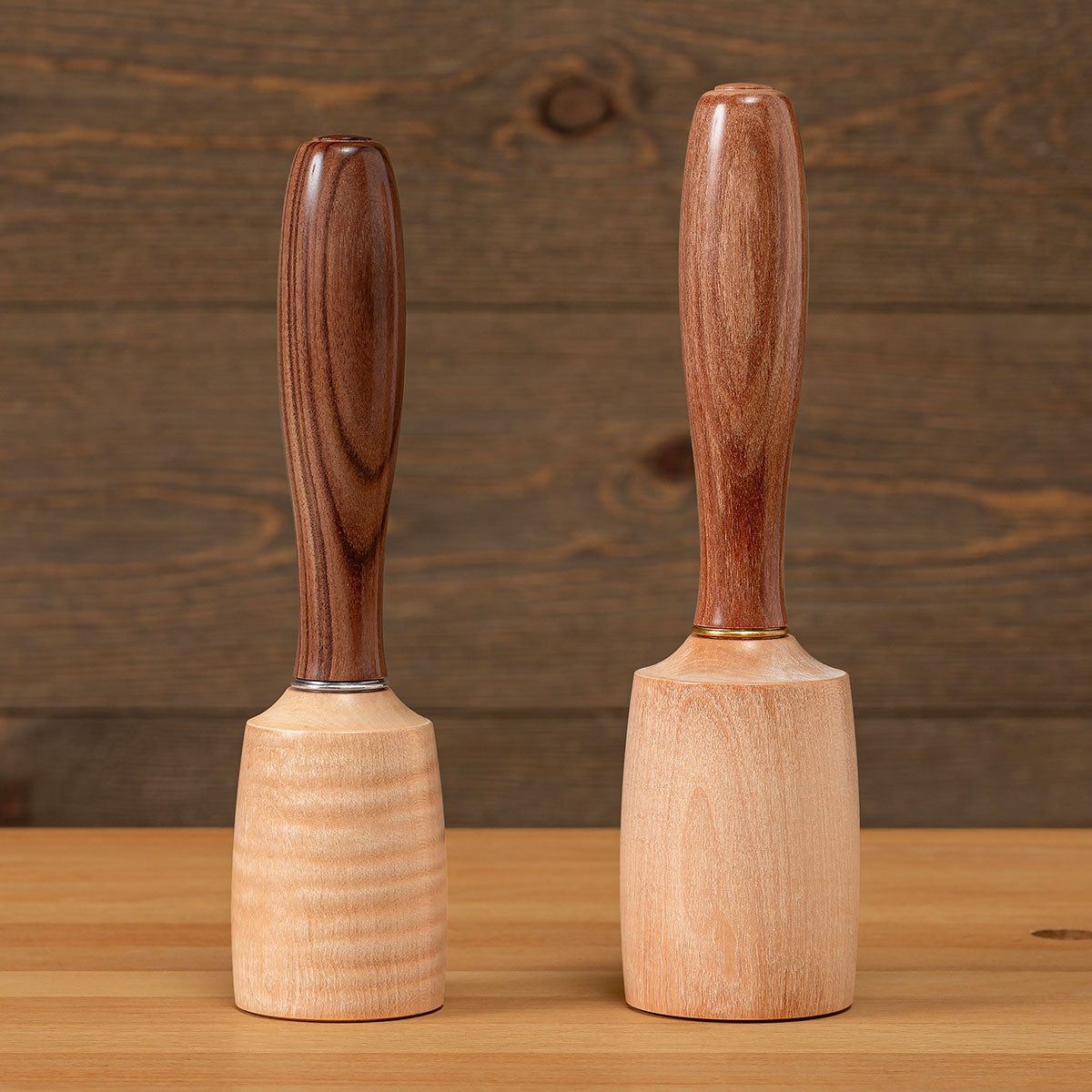 The Small Round Mallet shown on the left with Bolivian Rosewood handle and stainless-steel ferrule. The Large Round Mallet shown on the right with a Cherry handle and brass ferrule. Both sizes of mallet heads are resin-infused curly maple