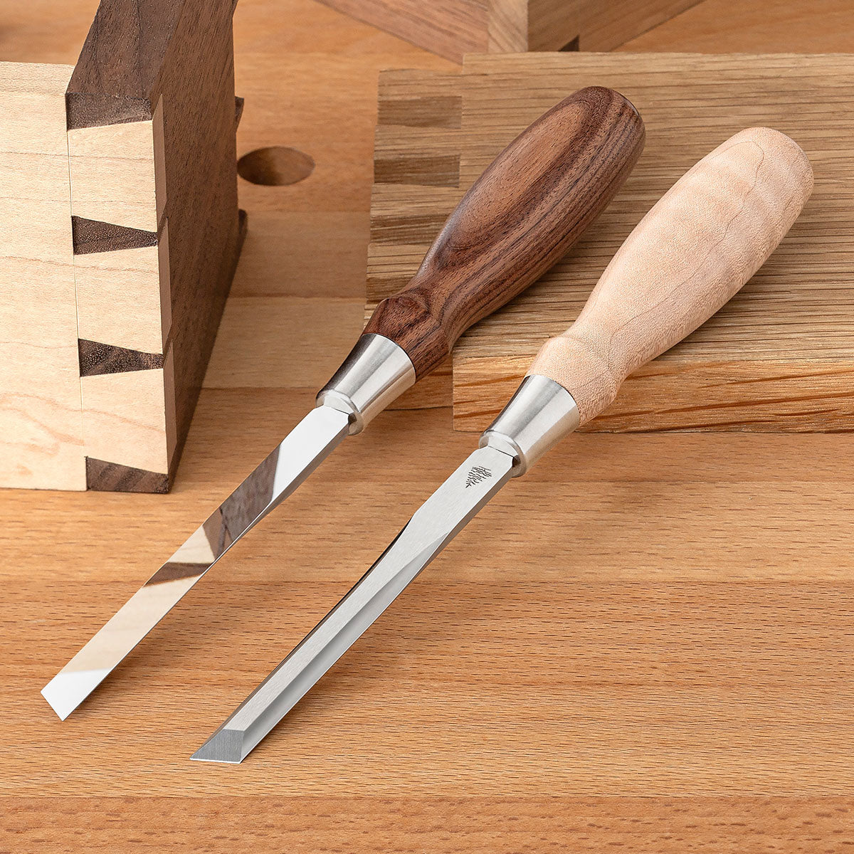 Two Blue Spruce Skew Chisels with 1/4” blades. Bolivian Rosewood handle on the left and a resin-infused Curly Maple handle on the right.