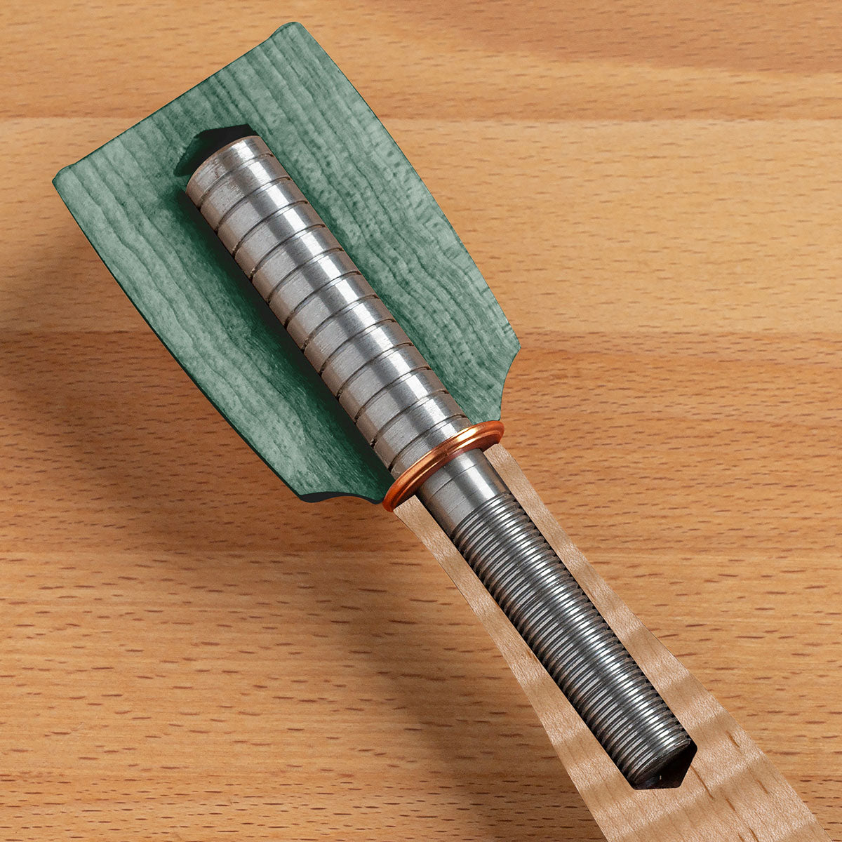 An inside look of a Blue Spruce mallet showing the steel rod that conjoins the head to the handle and adds mass and rigidity to the mallet.