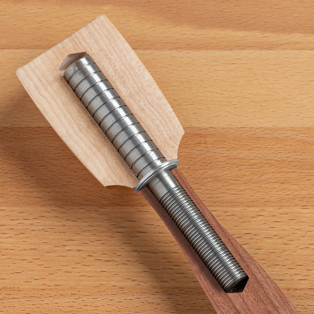 An internal view of the Blue Spruce Round Mallet showing the machined steel rod that extends between the two sections for added mass and rigidity.
